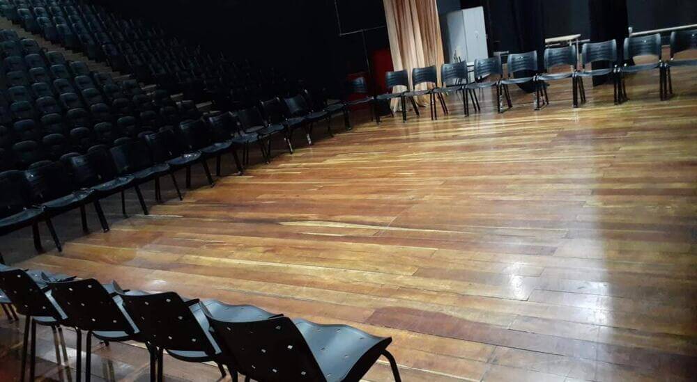 palco de teatro com piso de madeira maciça desgastado e opaco